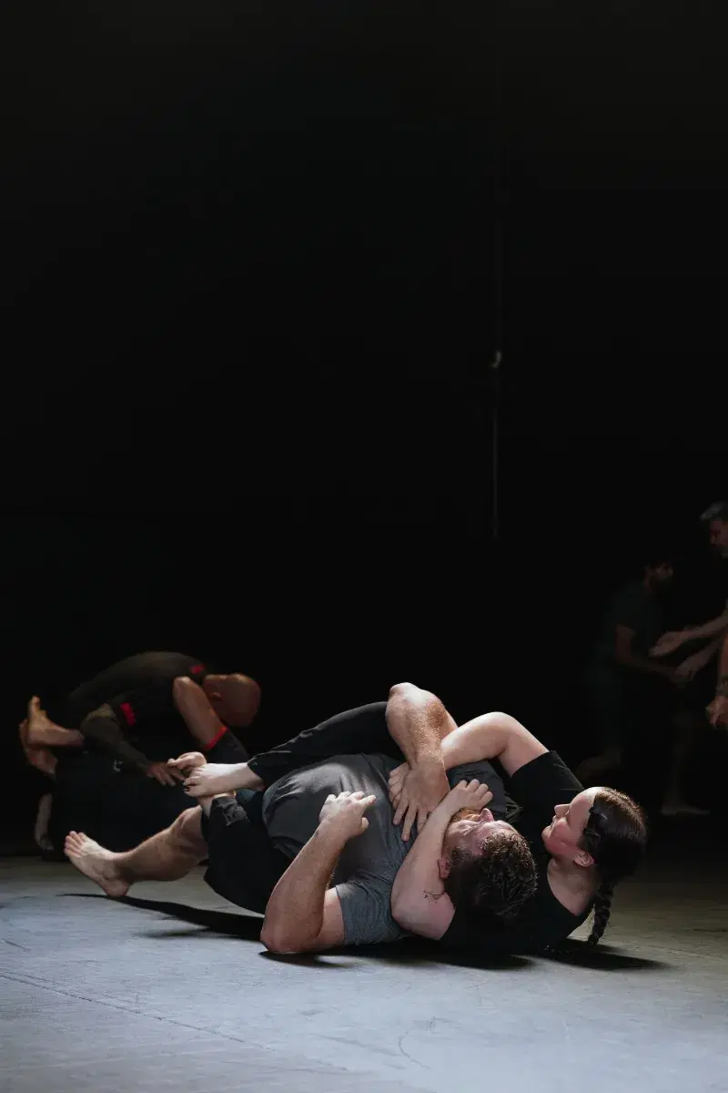 A man and a woman practising back control in an adult beginners jiu-jitsu class at Platinum Jiu Jitsu Oxenford