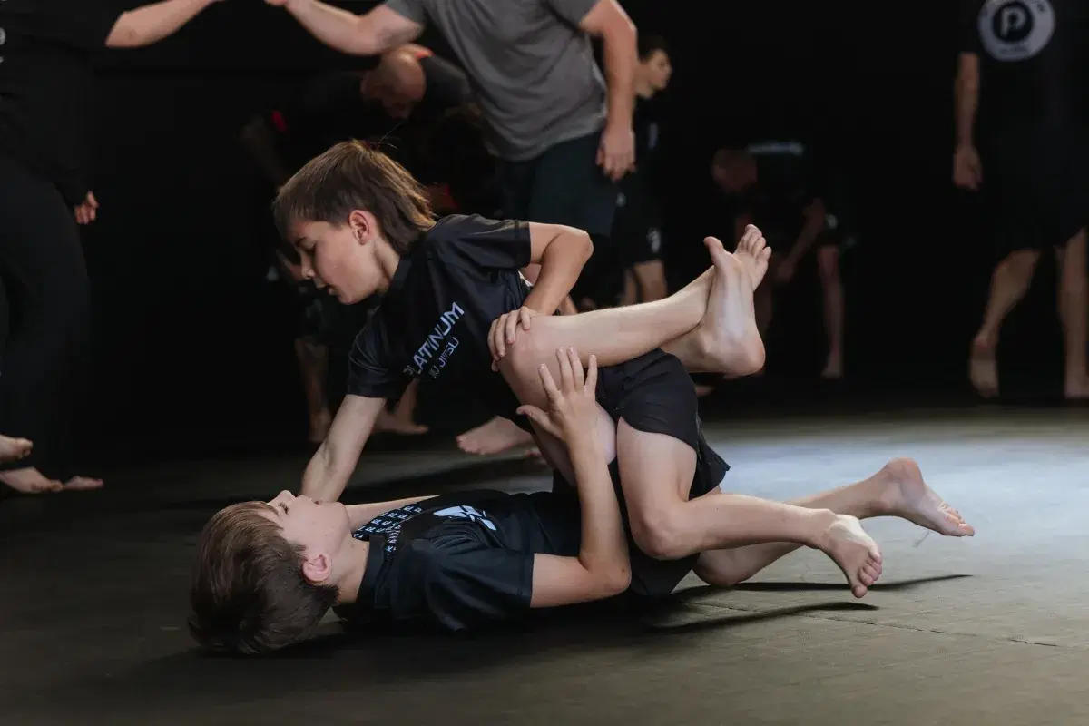 Two kids drilling a guard pass in the kids jiu-jitsu class at Platinum Jiu Jitsu Oxenford